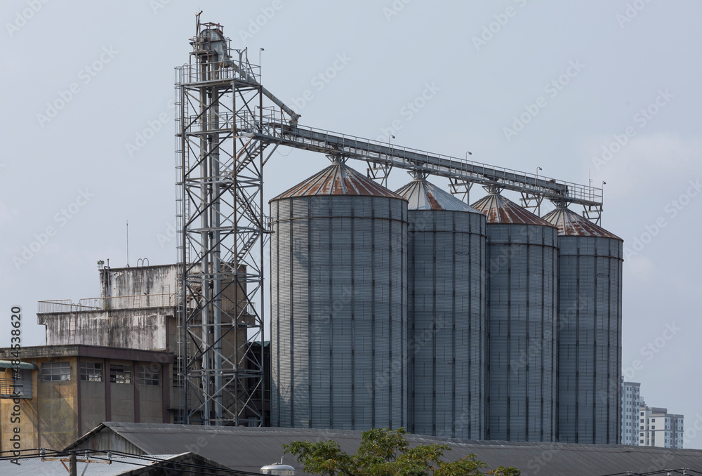 Large silos or industrial storage tanks outdoors on a sunny day