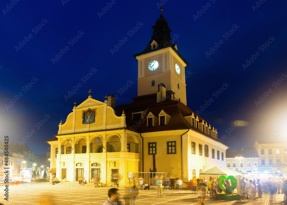 Nightlife of Brasov main Council Square with illuminated Town Hall, Romania
