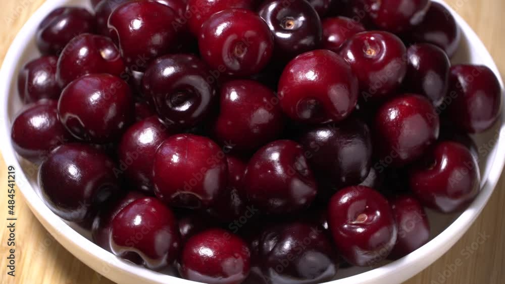 Fresh juicy red cherries rotation on a plate Fresh juicy red cherries rotation on a plate