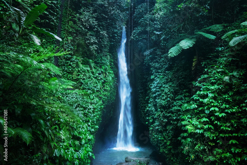 Beautiful hidden Leke Leke waterfall near Ubud in Bali, Indonesia. Secret Bali Waterfall in tropical rainforest.