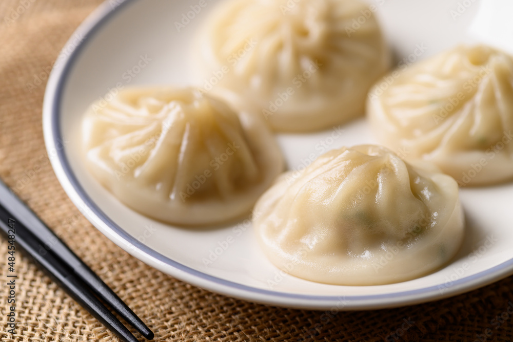 Xiao long bao, small Chinese steamed bun filling with minced pork Xiao long bao, small Chinese steamed bun filling with minced pork