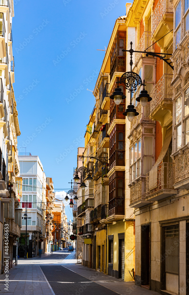 Picturesque architecture of typical narrow street in historic center of Spanish city of Cartagena on summer day