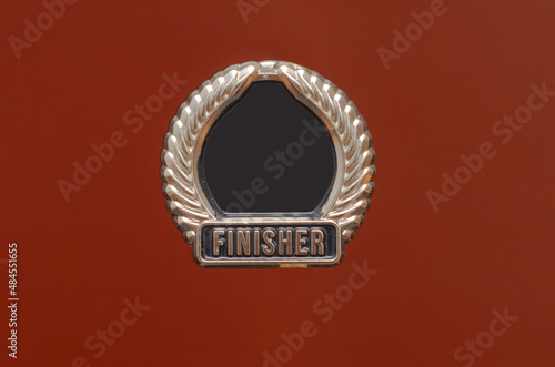 silver finisher icon on red background