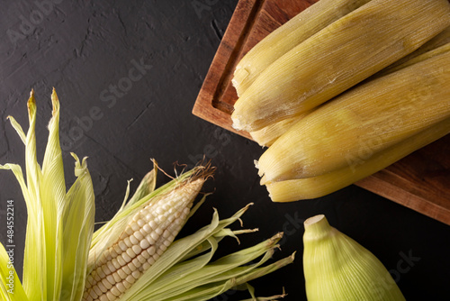 Tamales de Elote, also called Uchepos. Typical Mexican dish. Can be served with green salsa and accompanied by sour cream or served as a dessert covered with caramel or any other sweet topping photo