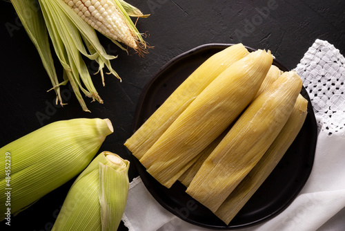 Tamales de Elote, also called Uchepos. Typical Mexican dish. Can be served with green salsa and accompanied by sour cream or served as a dessert covered with caramel or any other sweet topping photo