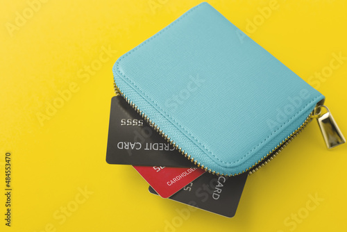 Credit cards in wallet on yellow background