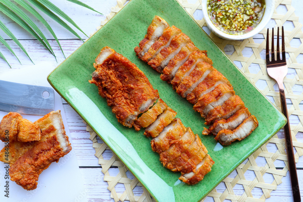 Deep fried pork belly with spicy sauce Flat lay food in Thai called
