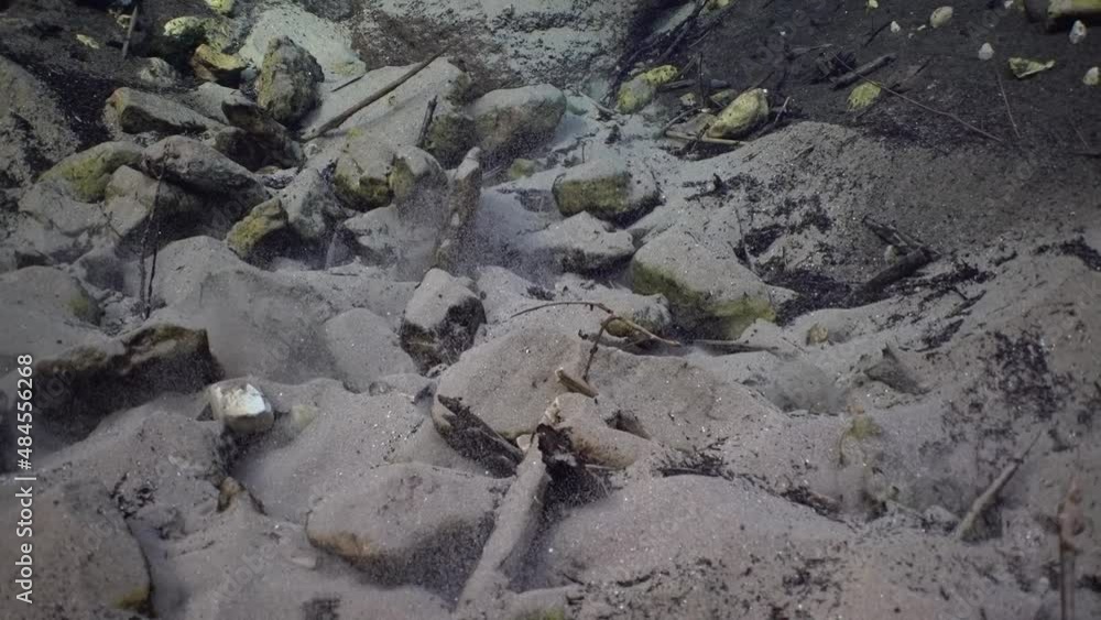 View of the freshwater spring with rocks on the bottom, close-up view. View of the freshwater spring with rocks on the bottom, close-up view.