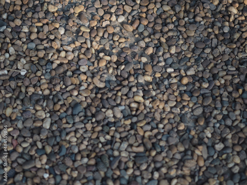Abstract background with pebbles small round sea stones Beach rocks Texture material nature, Rock the specifics, grey black color Abstract background with pebbles small round sea stones Beach rocks Texture material nature, Rock the specifics, grey black color