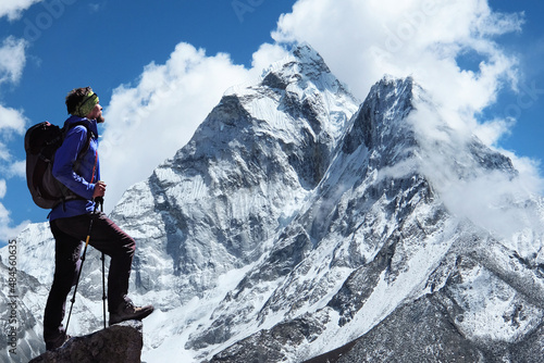 Climber reaches the summit of mountain peak enjoying the view of Ama Dablam on the way to Everest Base Camp. Sagarmatha national park, Khumbu valley, Nepal  Success, freedom and happiness © Andrii Vergeles