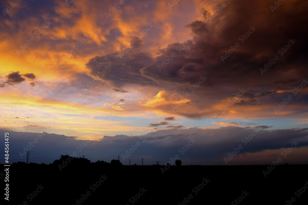 Beautiful sunset with golden orange clouds background. Dramatic background. Beautiful sunset with golden orange clouds background. Dramatic background.