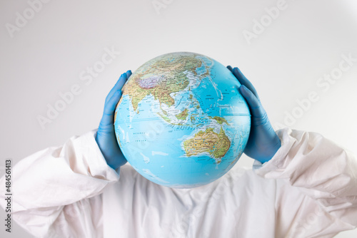 Doctor holding the planet Earth instead of head.