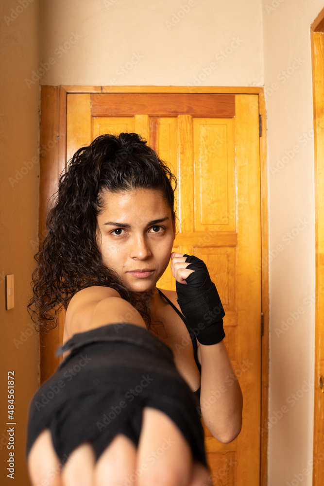 girl practicing boxing in a hotel room girl practicing boxing in a hotel room