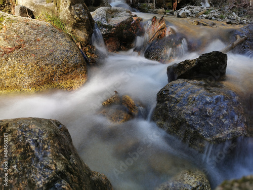 A scene of a creek streaming on big rough rocks in the wood, Cercedilla, Spain photo