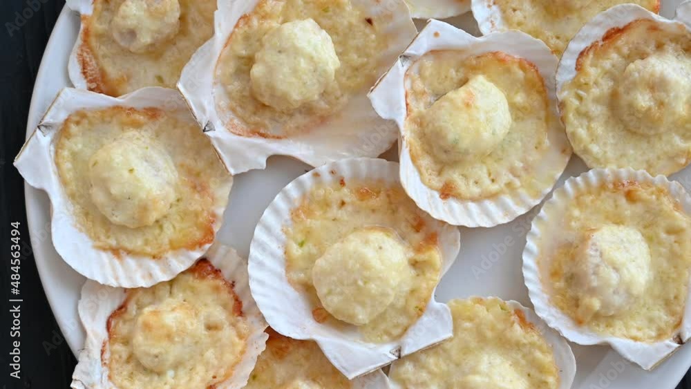 Plate with delicacy roasted scallops with cheese Plate with delicacy roasted scallops with cheese