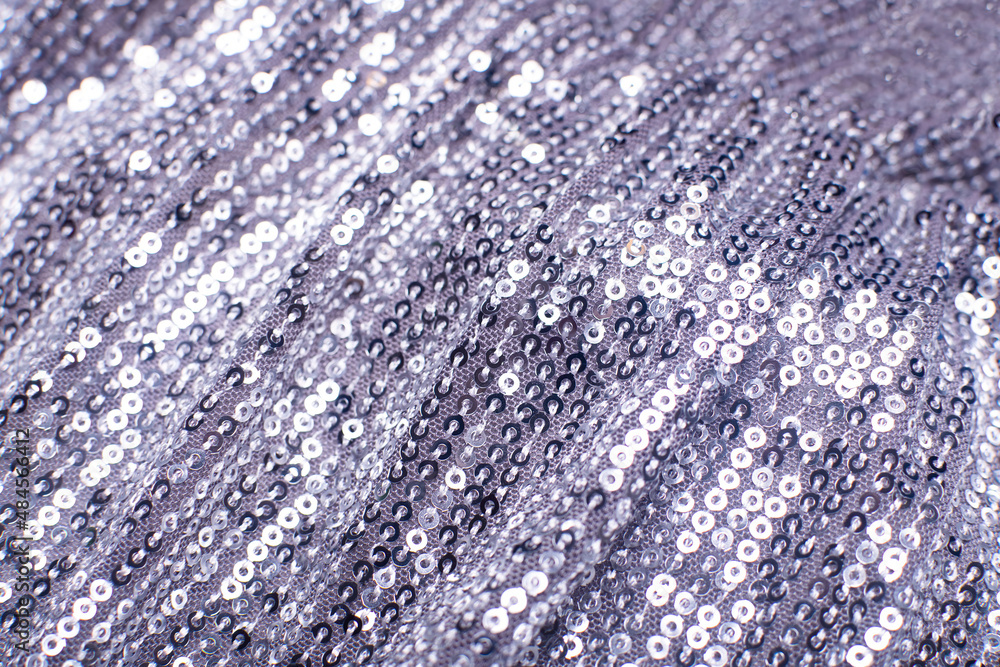 Pieces of cloth with silver sequins. Glitter background. Sequin texture Pieces of cloth with silver sequins. Glitter background. Sequin texture