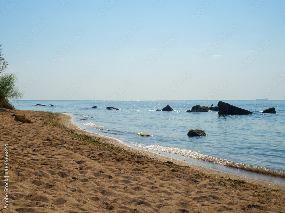 Beautiful sea at noon in summer, clear water, sand beach. silent waves are illuminated by the midday sun. seascape in Ukraine. Beautiful sea at noon in summer, clear water, sand beach. silent waves are illuminated by the midday sun. seascape in Ukraine.