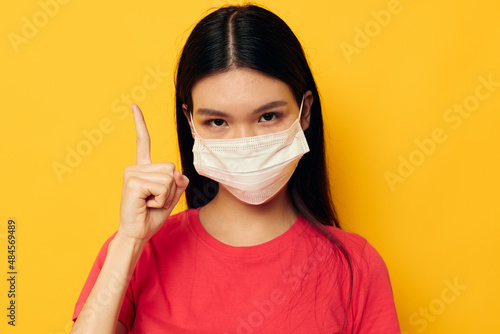 woman with Asian appearance medical face mask safety isolated background unaltered © Tatiana