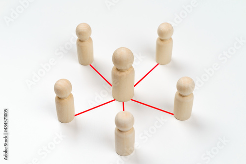 Wooden peg dolls are connected together with red lines on white background. Teamwork, Leadership, Business, human resource management Concept.