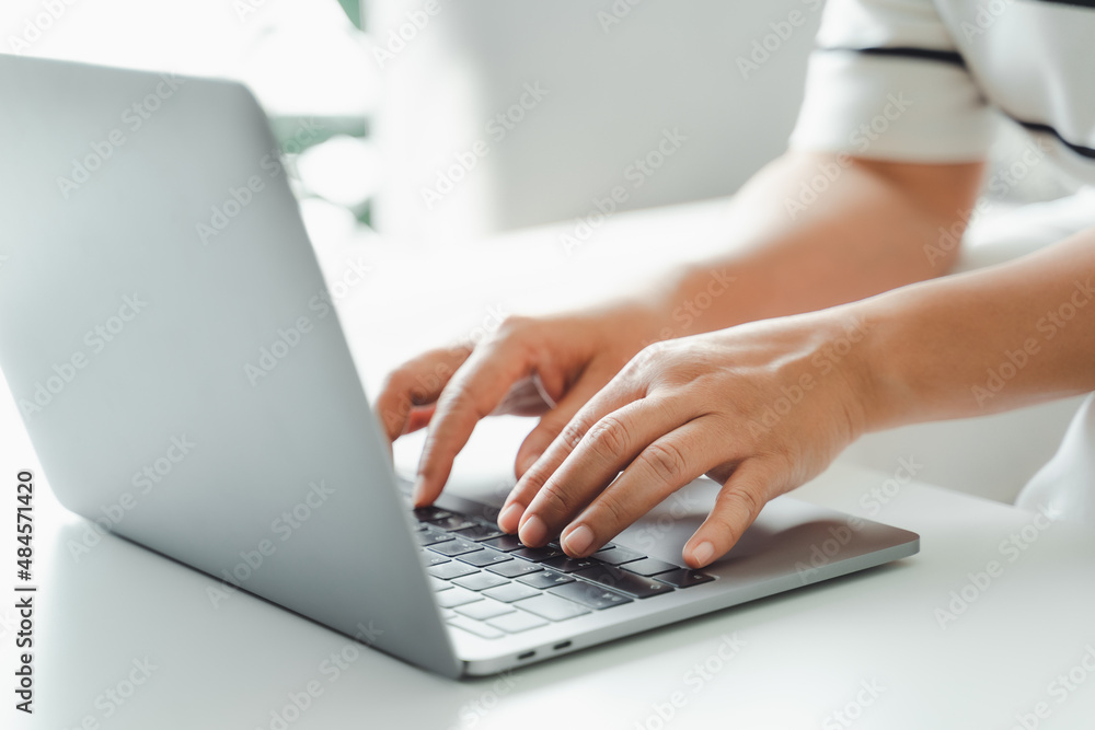 Close up of woman hands typing on laptop keyboard on the table at home office or workplace. Close up of woman hands typing on laptop keyboard on the table at home office or workplace.