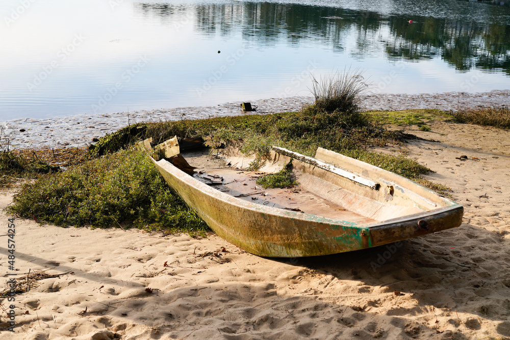 Hossegor old wooden boat abandoned on the sandy beach of the lake Hossegor old wooden boat abandoned on the sandy beach of the lake