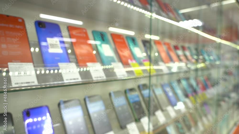 Shelf with new smartphones in a hardware store. Close-up. PAN. Nobody Shelf with new smartphones in a hardware store. Close-up. PAN. Nobody