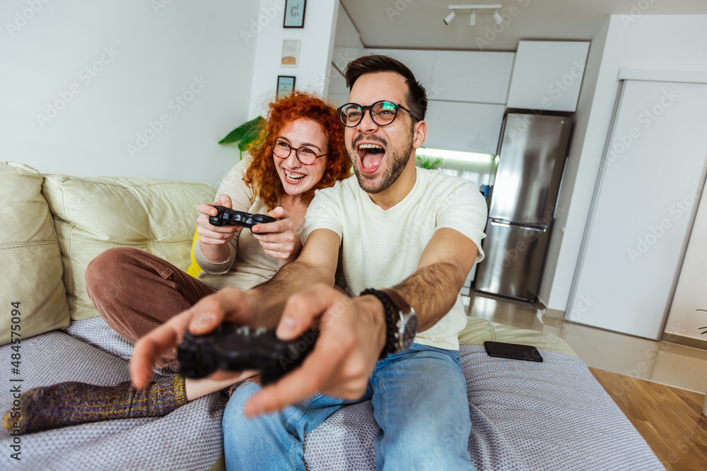Loving couple are playing video games at home. Loving couple are playing video games at home.