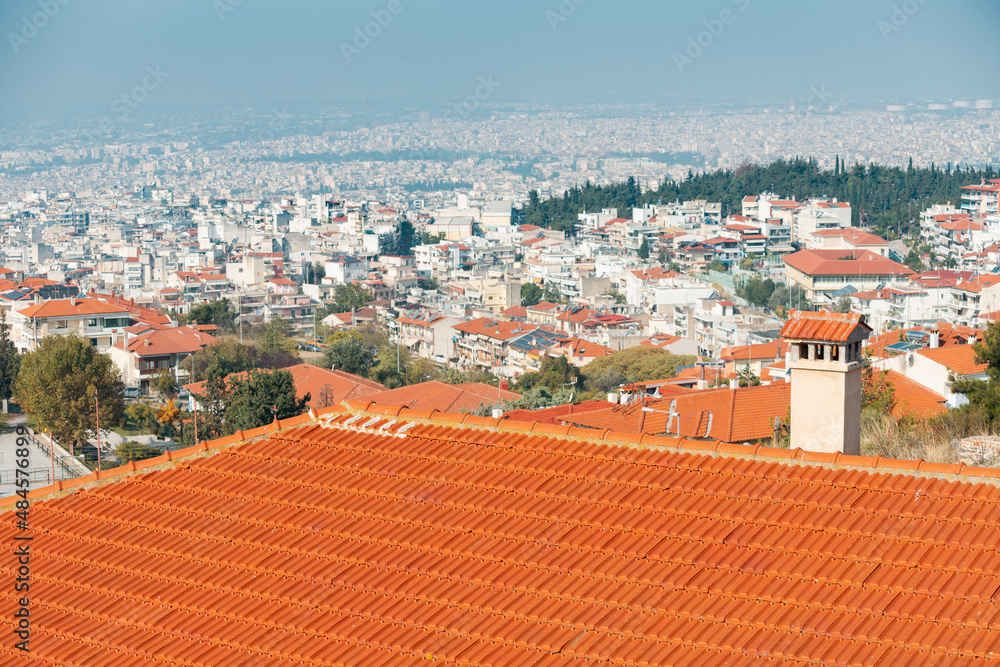 Orange tile roof and chimney in a European city