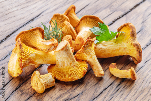 Golden chanterelle mushrooms on the old wooden table.