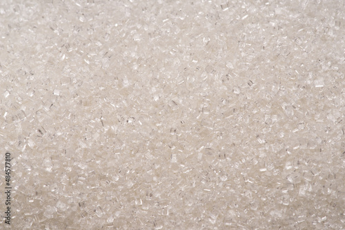 White refined sugar granules close-up. Food background.