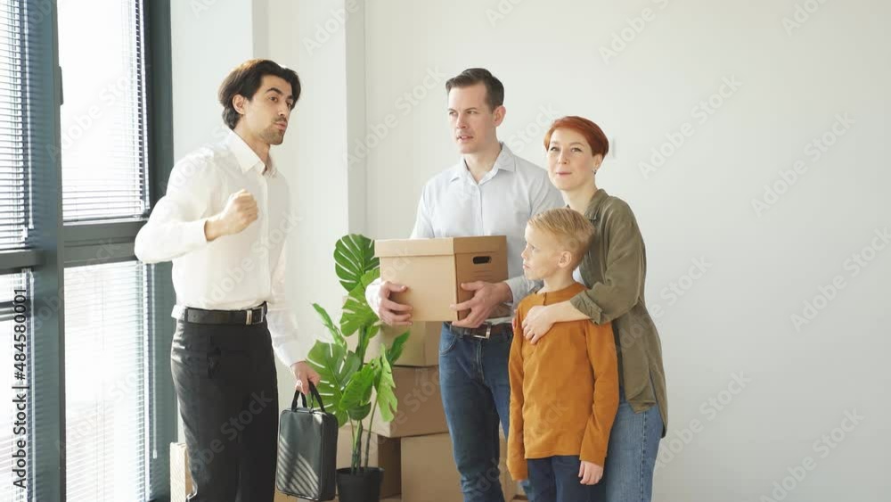 Caucasian Real Estate Agent In Formal Wear Representing New House To Customers. Caucasian Real Estate Agent In Formal Wear Representing New House To Customers.