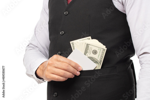 Handsome business man in black suit put or take out credit card and money in pocket isolated on white background. Business, technology, ecommerce and online payment concept.