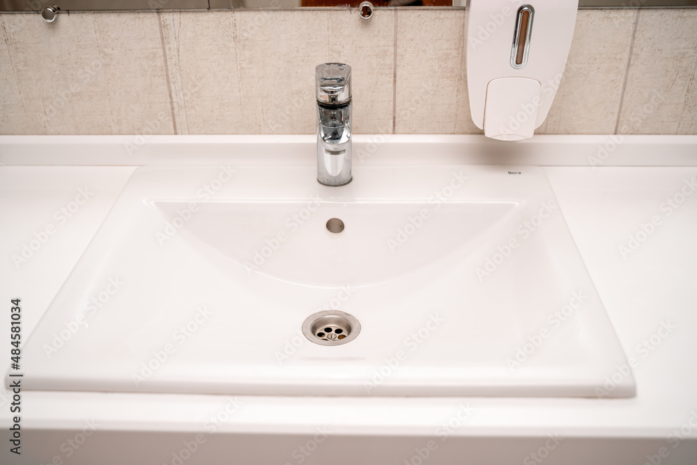 Public sinks, Handwashers for people using public toilets, Cleaning after using the toilet service, Public toilets and hygiene concept. Public sinks, Handwashers for people using public toilets, Cleaning after using the toilet service, Public toilets and hygiene concept.