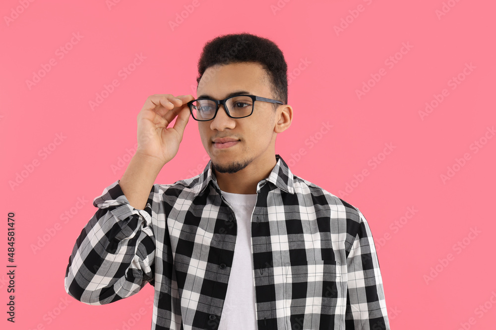 Young man in glasses on pink background Young man in glasses on pink background