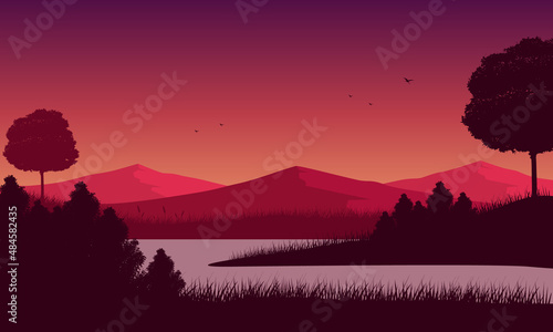 Great mountain panorama with pine trees and lake at sunset from the edge of the city