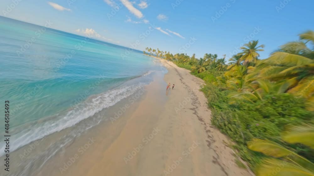 Drone flying over people and blue helicopter along Playa Esmeralda, Miches in Dominican Republic. Aerial acrobatic fpv Drone flying over people and blue helicopter along Playa Esmeralda, Miches in Dominican Republic. Aerial acrobatic fpv