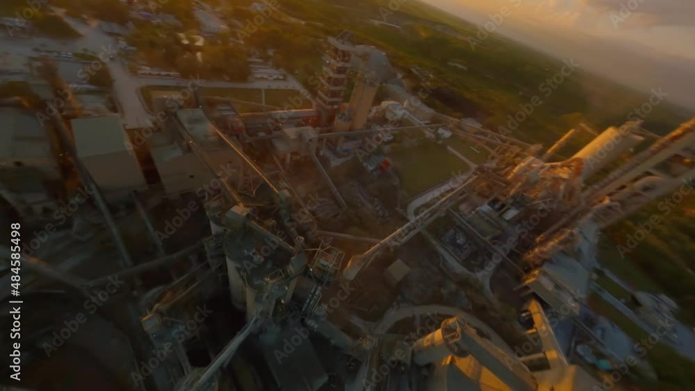 Racing drone flying over cement factory with Mauricio Baez BridgeBridge in background, San Pedro de Macoris in Dominican Republic. Aerial fpv Racing drone flying over cement factory with Mauricio Baez BridgeBridge in background, San Pedro de Macoris in Dominican Republic. Aerial fpv