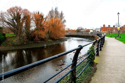Empty foot path by river Dodder in Dublin city, Metal fence. Place for walk and relaxation and sport activity. Wild bird habitant.