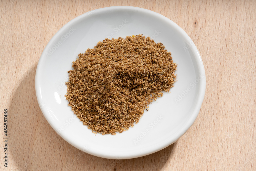 Detailed and large close up shot of powdered coriander on a small plate Detailed and large close up shot of powdered coriander on a small plate