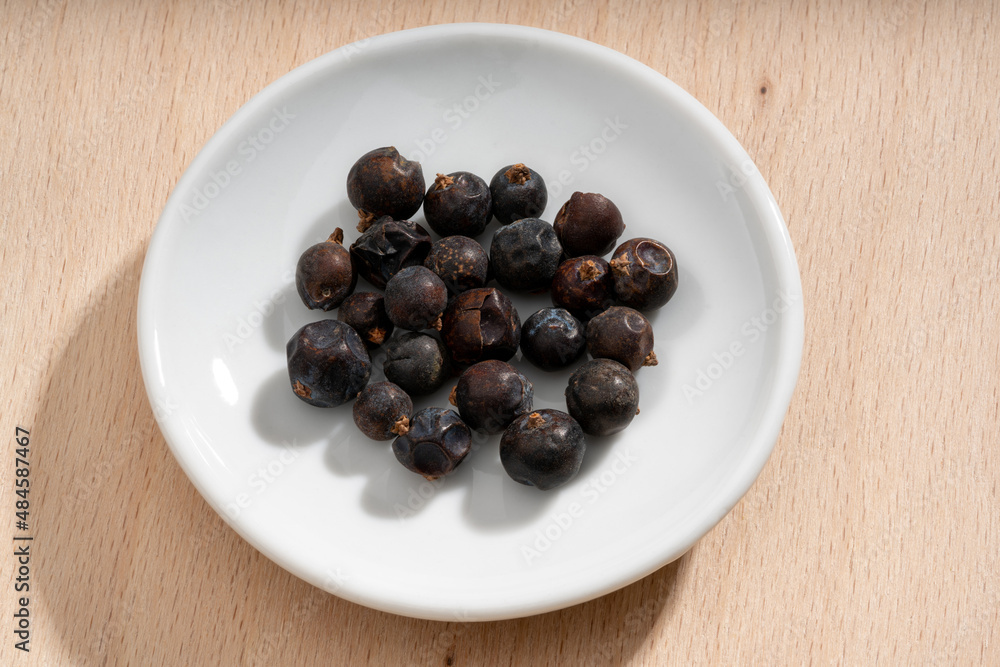 Detailed and large close up shot of juniper berries on a small plate Detailed and large close up shot of juniper berries on a small plate