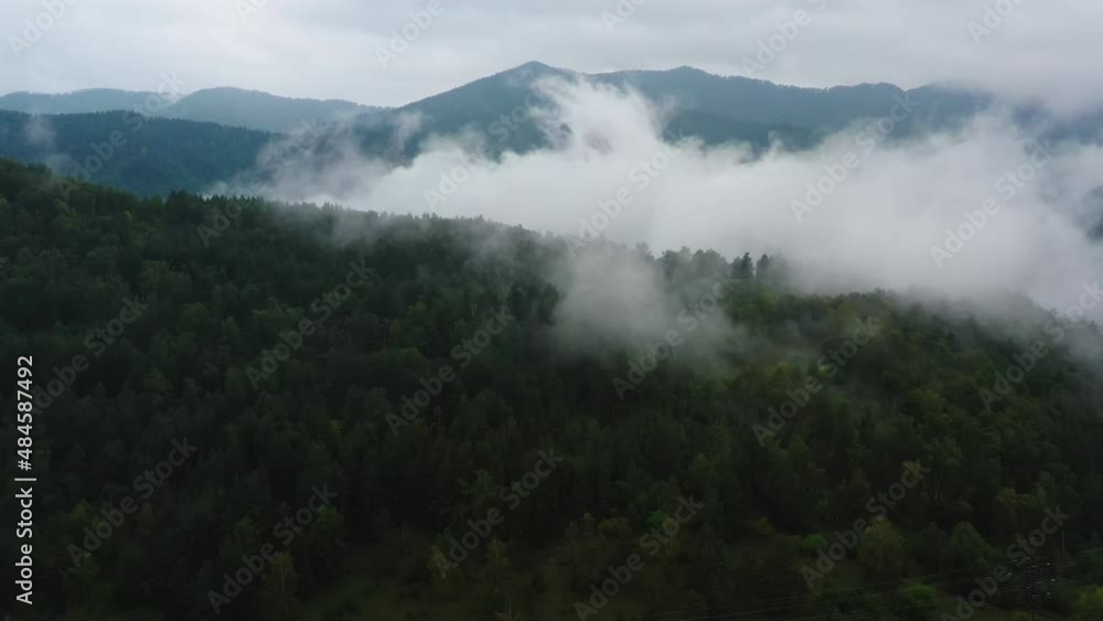 mountains and forest in the clouds view from above mountains and forest in the clouds view from above