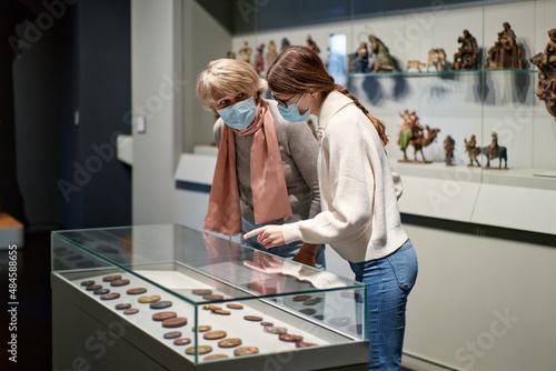 Woman and his daughter view the artworks