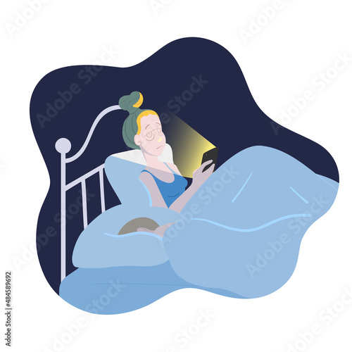 Young woman checking her phone in bed at night