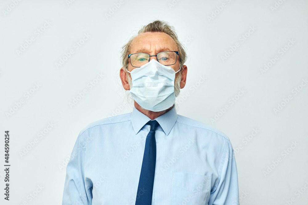 Portrait of happy senior man in shirt with tie medical mask safety light background Portrait of happy senior man in shirt with tie medical mask safety light background