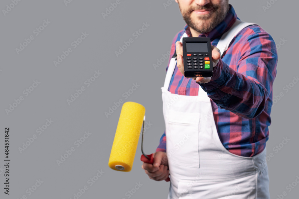 Professional painter holding a POS terminal Professional painter holding a POS terminal