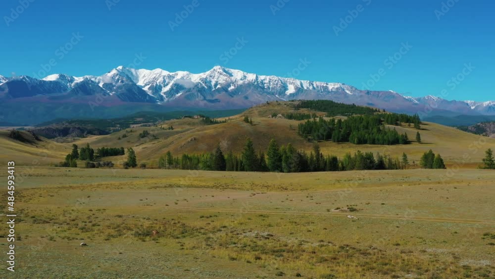 fields and mountains with snow-capped peaks fields and mountains with snow-capped peaks