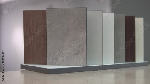 Furniture surface, granite, stone sample tiles for customers. Choosing design for house kitchen interior, countertop table decoration. Marble and wood texture, white, grey ahd brown copies. photo