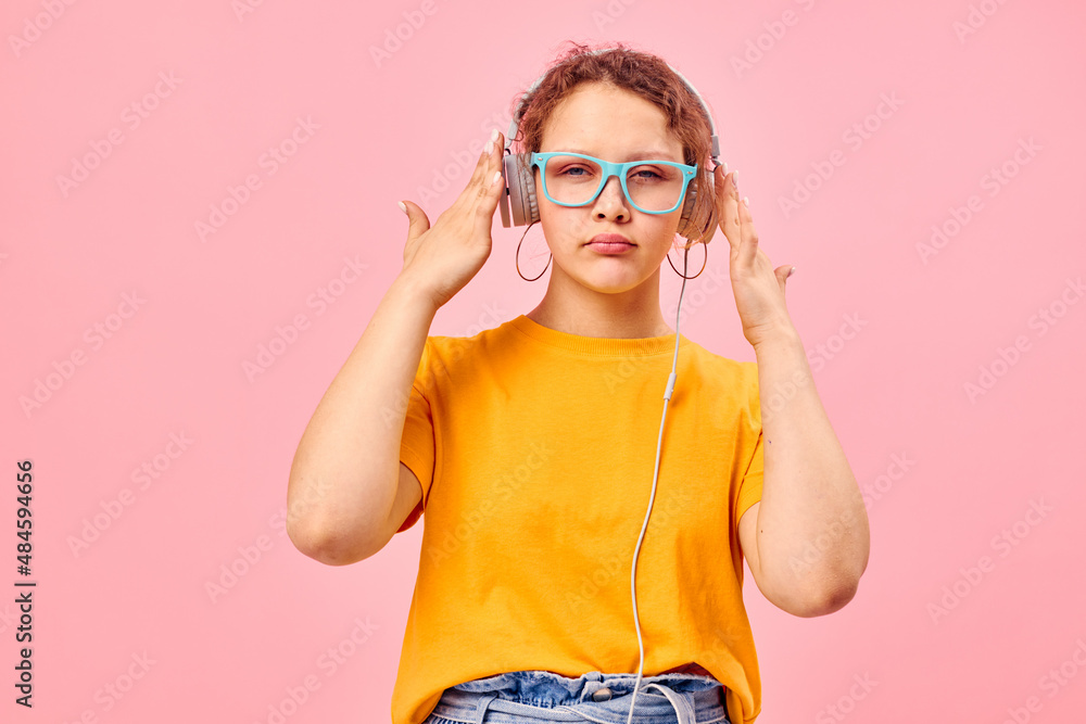 funny girl yellow t-shirt headphones entertainment music fun pink background unaltered funny girl yellow t-shirt headphones entertainment music fun pink background unaltered