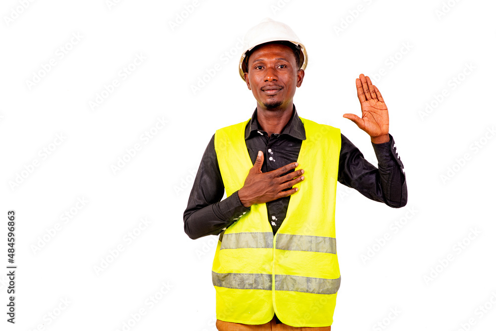 young man construction engineer making an oath gesture. young man construction engineer making an oath gesture.
