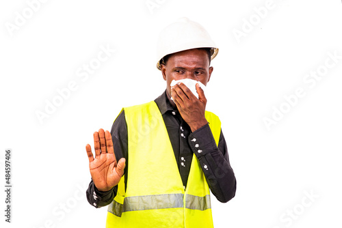 young sick engineer man holding handkerchief and making stop gesture.